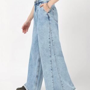 Sale A person models a pair of light wash, high-waist, wide-leg denim jeans featuring front pleats and a heavily frayed, raw hemline.