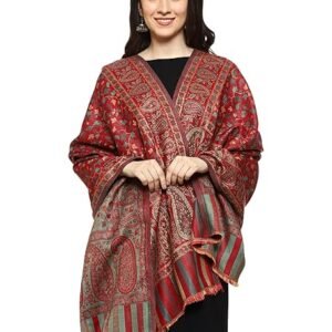 A woman modeling a large, luxurious red and gold paisley shawl/stole, draped over a black dress, showing the detailed zari work and tasseled edges.